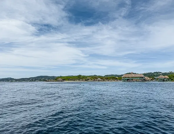 View of the Roatán coastline and nearby cays, including Brady’s Cay, taken from the snorkeling boat during our combo tour.