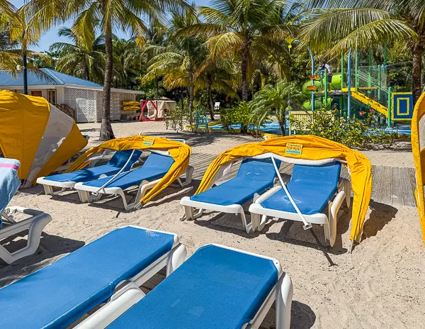 Clamshell loungers for rent near the family splash zone at Harvest Caye, Belize on Norwegian Cruise Line’s private island.