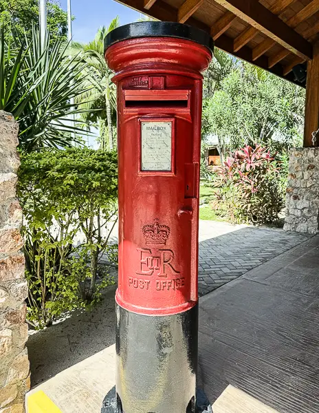 Red British-style mailbox at Harvest Caye, Belize, where visitors can mail postcards home from Norwegian Cruise Line’s private island.