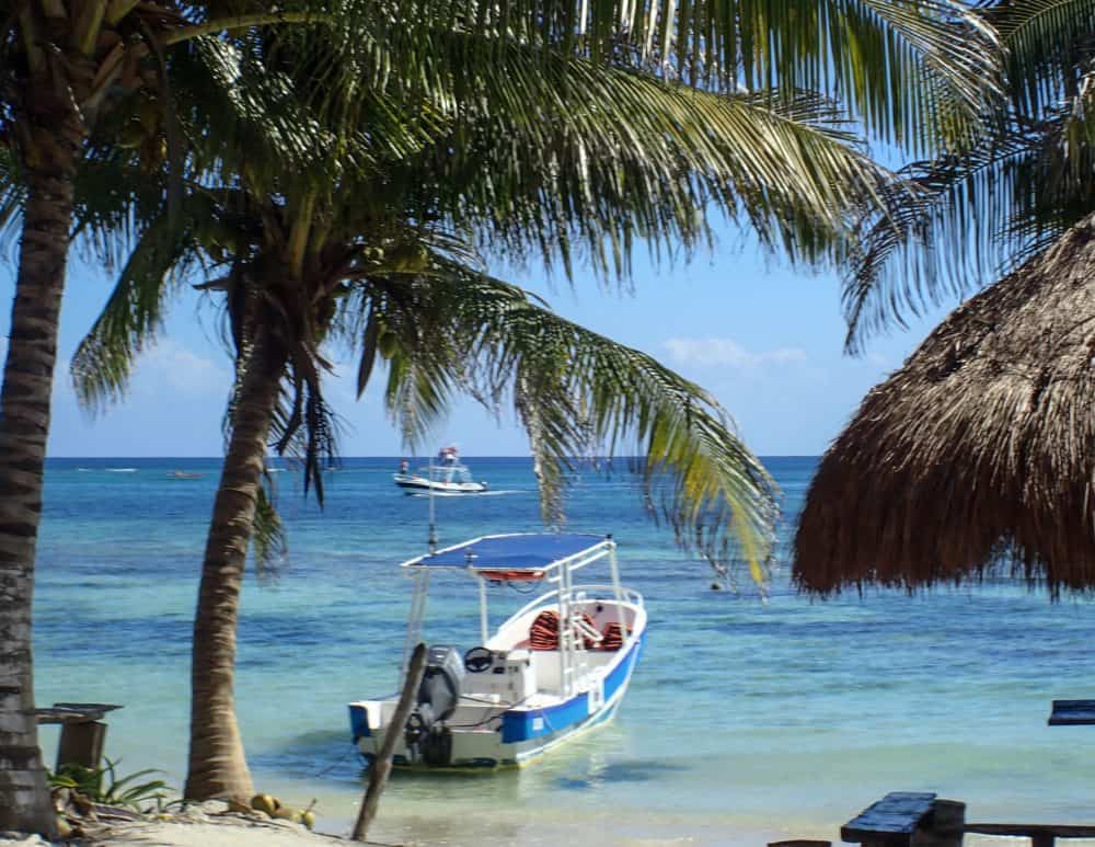 Beach and boat view from the road exploring Mahahual • TastyItinerary.com