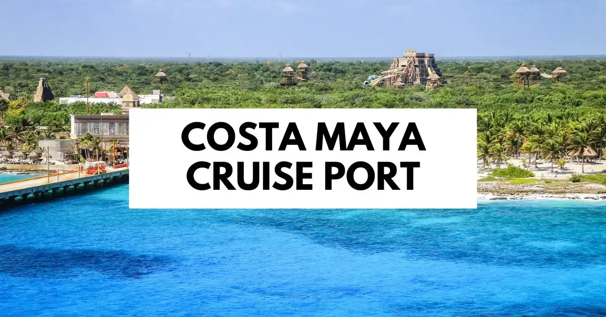 featured blog image | view of the Costa Maya Cruise Port with clear blue waters, a lush green landscape, and a dock extending towards thatched-roof structures and ancient Mayan-themed buildings. The image has overlay text reading "COSTA MAYA CRUISE PORT"