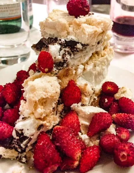 A meringue cake smothered with fresh wild raspberries