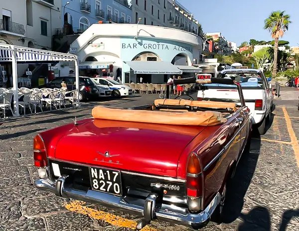 red convertible fiat driving as an open air taxi in capri