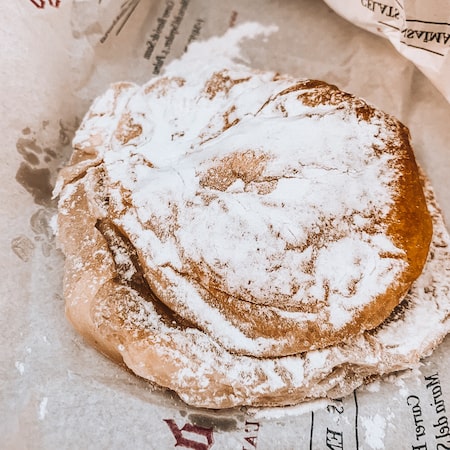 ensaïmada covered in powdered sugar from Can Joan de sAigo Cafe