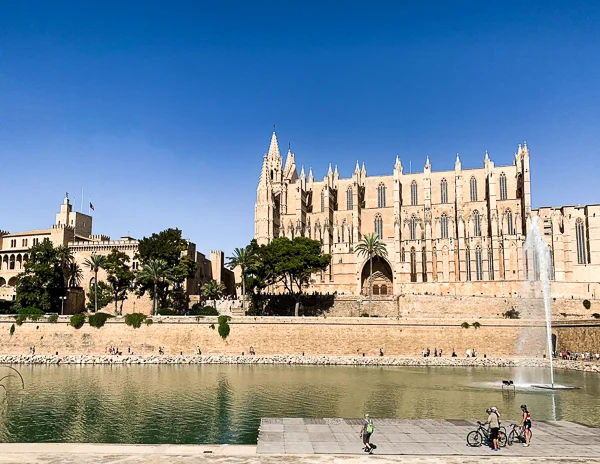 Bikers overlooking Parc de Mar and Palma's La Seu Cathedral