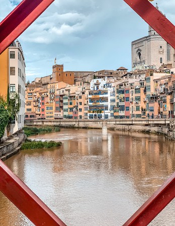 view of colorful homes and river in Girona, Spain