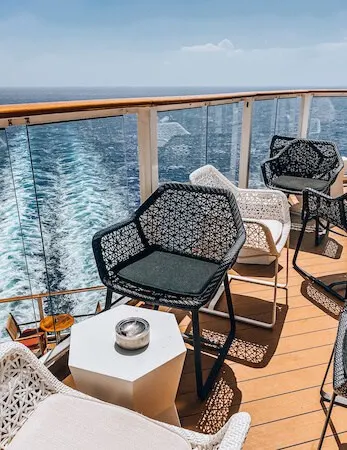 Outdoor bar seating on the back deck of cruise ship