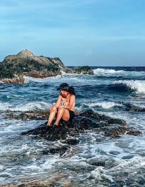 Posing on a rock at the rocky beach of Arikoki National Park