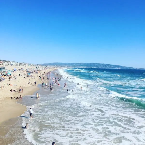 People frolicking at the shores of Manhattan Beach, California