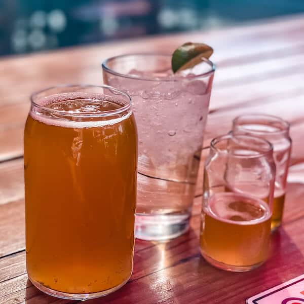 Beer samples, a pint of beer, and glass of sparkling water at Fire Rock Burgers and Brew