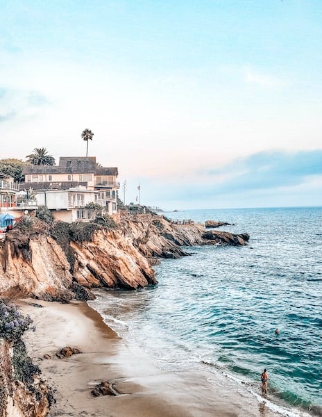 a home sitting on rocky shores of the Pacific in Laguna Beach
