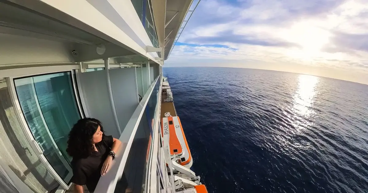 featured image without text | kathy standing outside in the cruise ship balcony with view of the ocean