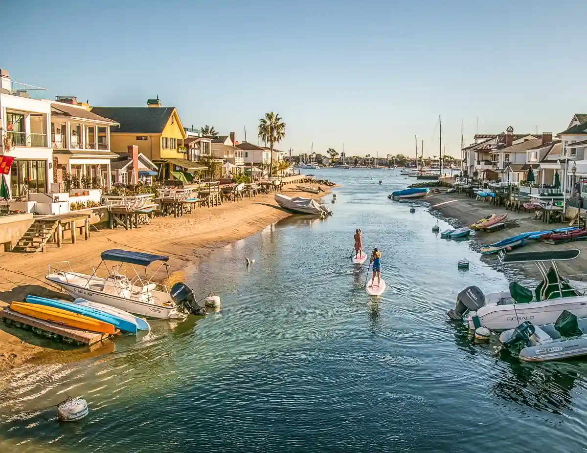 paddleboarders along the canals of balboa island