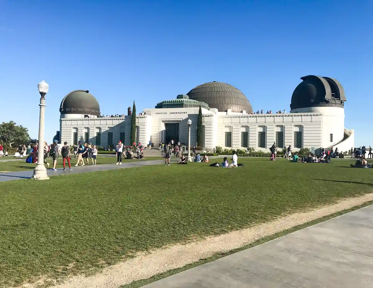 outside of griffith observatory in Los Angeles people are walking around and having picnics