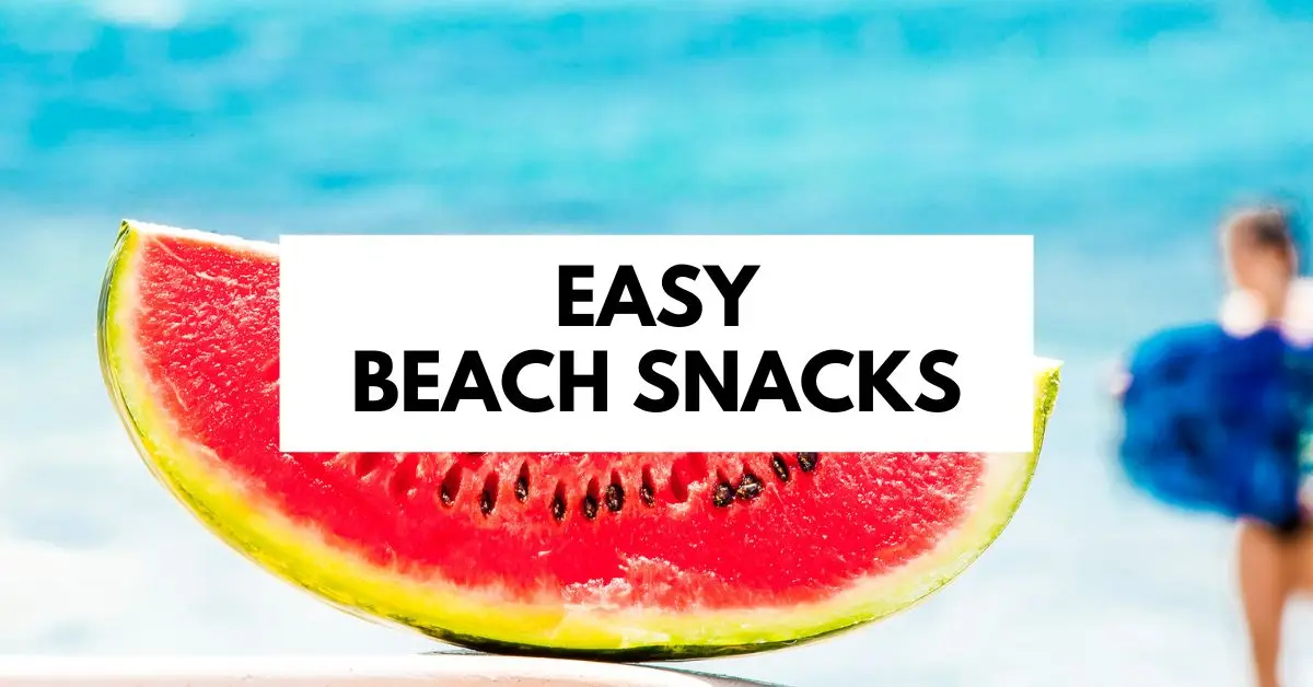 featured blog image of a vibrant slice of watermelon with the caption "EASY BEACH SNACKS" overlaid on it. The background is a blurred seaside scene, The focus on watermelon