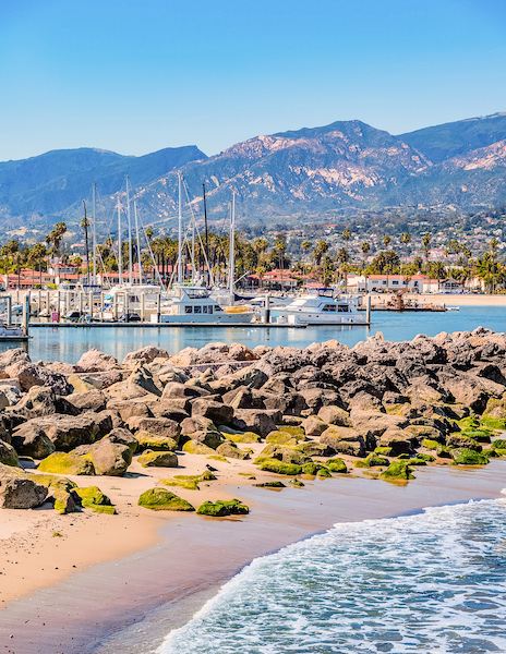 rocky shore and bay of harbor with boats