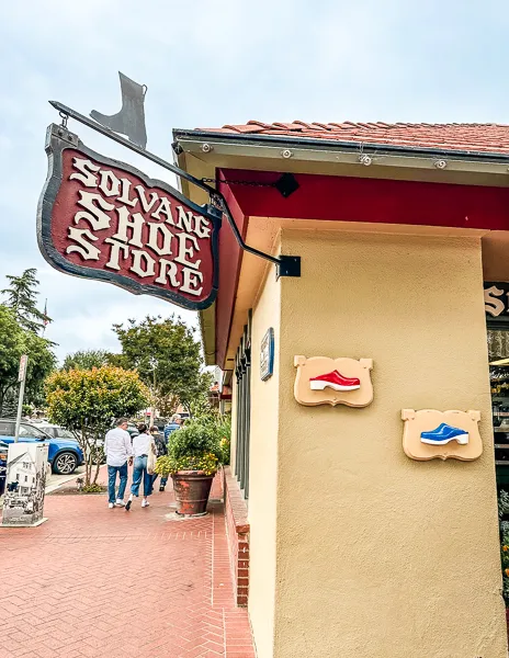 the Solvang Shoe Store with decorative clog plaques on the wall beside it
