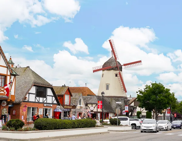 A traditional Danish windmill stands along Copenhagen Drive amid the charming buildings of Solvang.