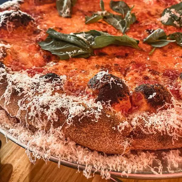 pizza crust dusted with parmesan cheese