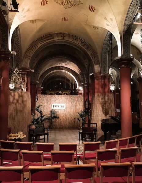 inside st. marks church with seating and stage set for opera performance