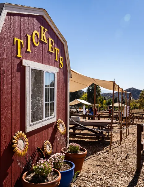 Red ticket booth with 'Tickets' sign at Los Rios Rancho.