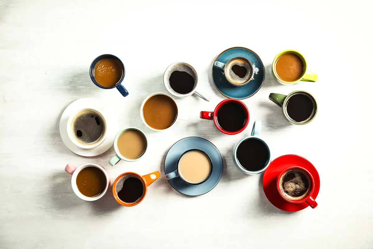 featured blog image | gifts for coffee lovers | many colorful mugs filled with coffees against a white background