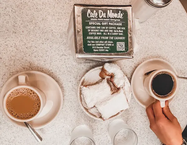 2 cups of coffee and a plate of beignets