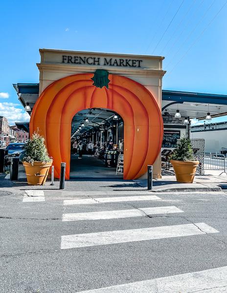 french market in the french quarter decorated for fall with a pumpkin