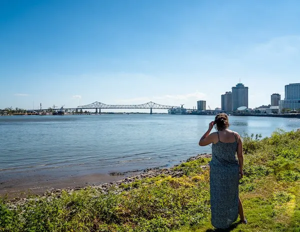 admiring the view of the Mississippi river and crescent city connection bridge