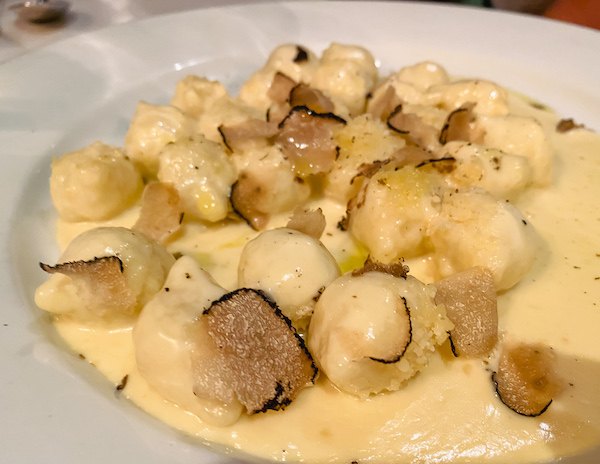 gnocchi in a cream sauce with shaved black truffles