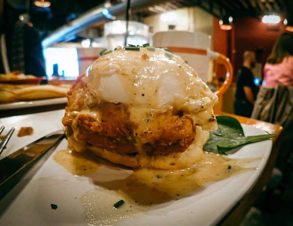 fried chicken on a biscuit with a poached egg