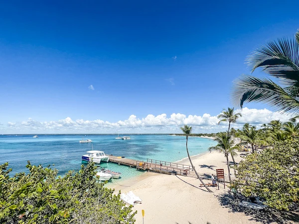 view of white sandy beach, dock and crystal blue waters