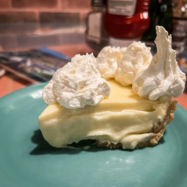 layered key lime pie topped with whip cream