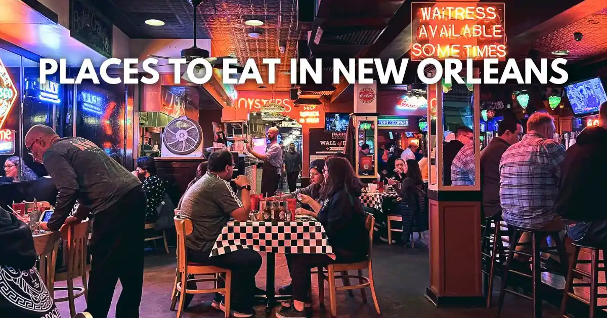 featured blog image: Diners inside Acme Oyster House in New Orleans, surrounded by neon lights, checkered tablecloths, and a lively atmosphere. Overlay text reads: Places to Eat in New Orleans.
