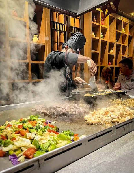 check serving and cooking over hibachi grill