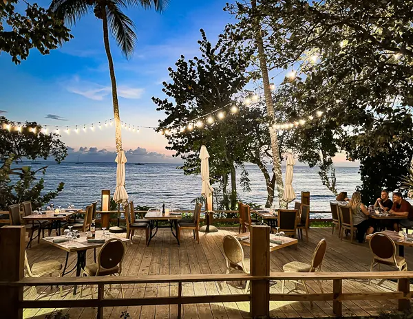 wooden deck with string lights and restaurant tables