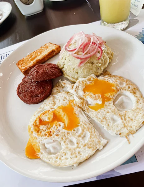 typical Dominican breakfast:fried eggs, magu (mash plantains), fried salami and fried cheese