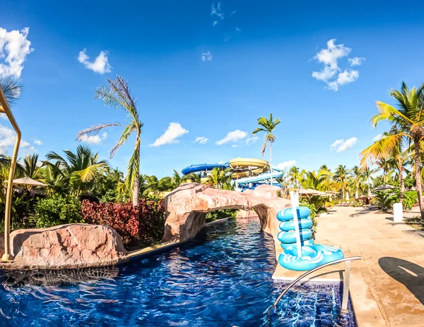 pool, water tubes and palm trees from a waterpark