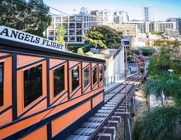 View of Angels Flight funicular in Downtown Los Angeles with its iconic orange car climbing the hill toward Bunker Hill.
