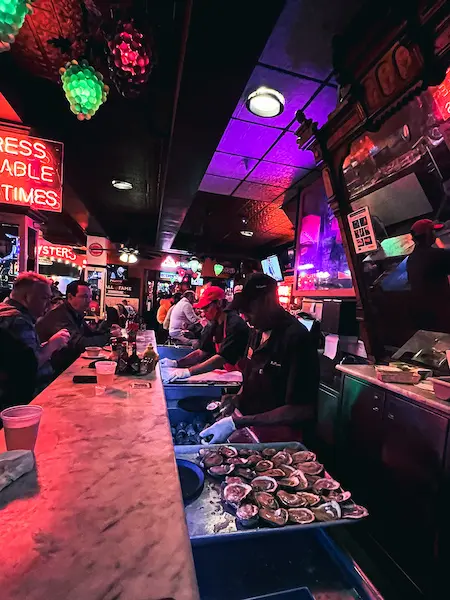 shucking raw oysters at acme