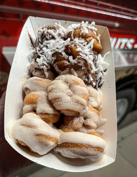mini donuts covered in cinnamon sugar and glaze and chocolate coconut