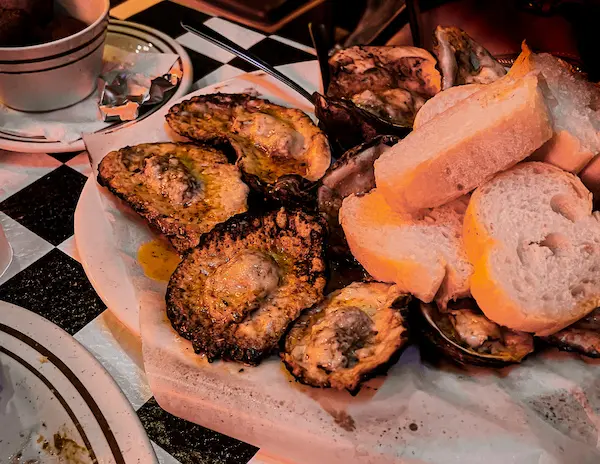 charbroiled oysters and pieces of bread