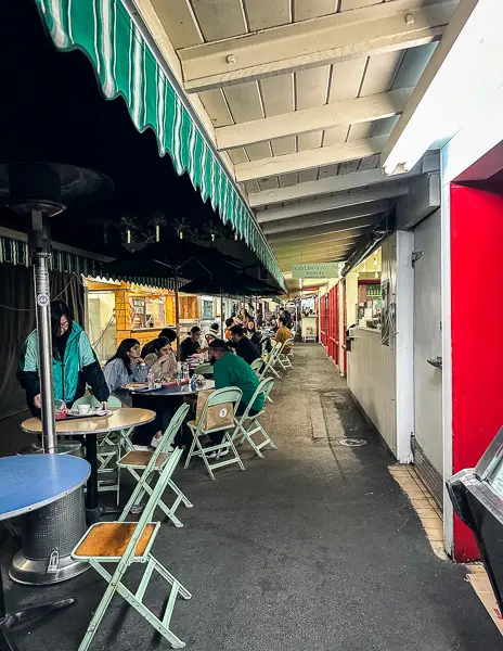 relaxed setting with outdoor seating along the corridor of the market.