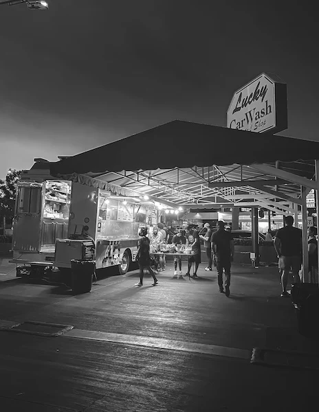 el pollos taco truck set up under the lucky car wash sign