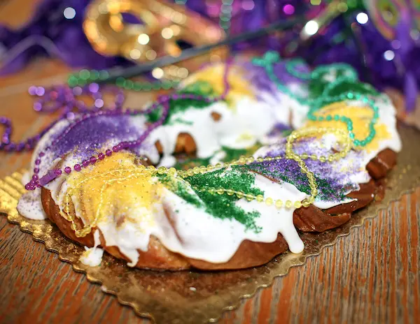 a round ring cake with icing and colorful sprinkles