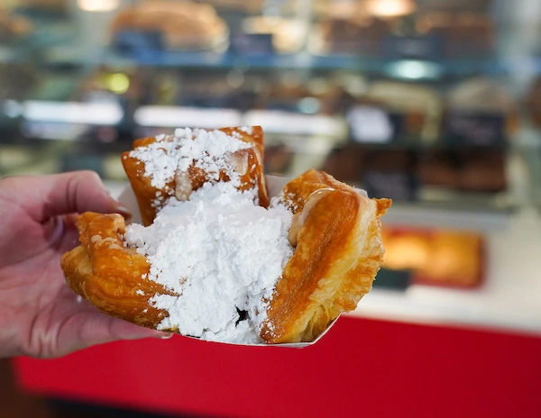pralined filled beignets topped with powered sugar