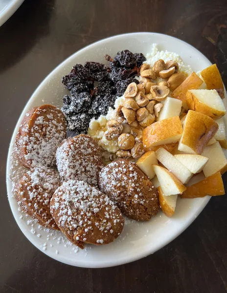 fried biscuits with ricotta, honey, fruit and raisins