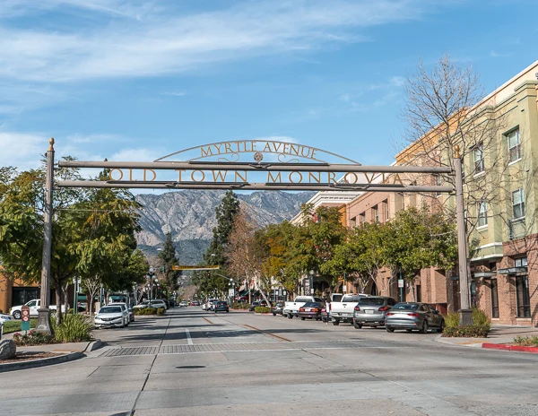 The Old Town Monrovia gateway sign over Myrtle Avenue with mountains in the background