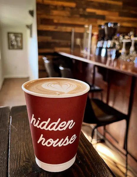 red coffee cup with hidden house script