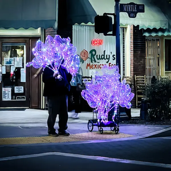 a man holding light up balloons